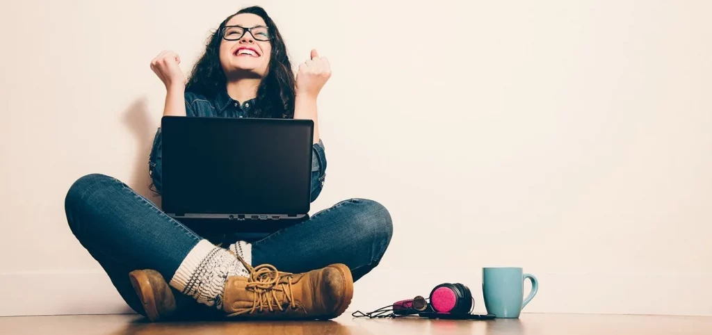 Happy woman sitting with laptop